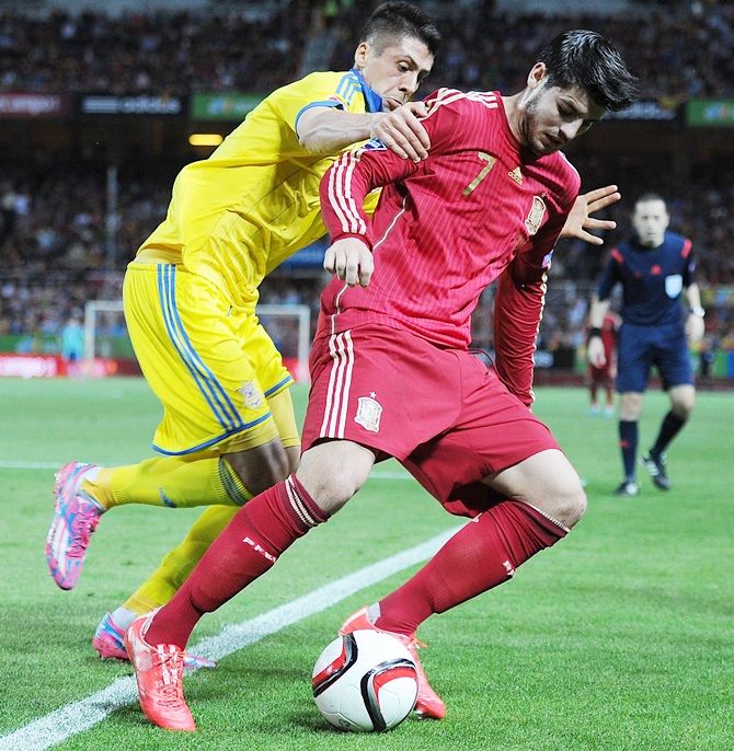 Alvaro Morata of Spain battles for the ball against Yevhen Khacheridi of Ukraine 