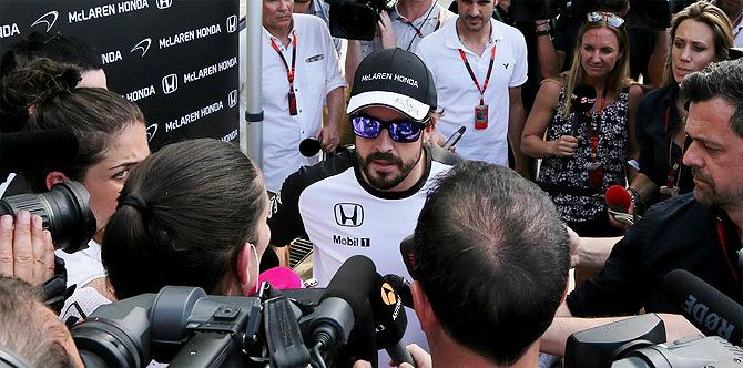 Fernando Alonso gives interviews to the media at the Sepang circuit in Malaysia on Saturday