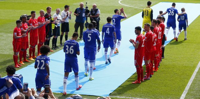 Liverpool players form a guard of honour as Barclays Premier League Champions Chelsea come out