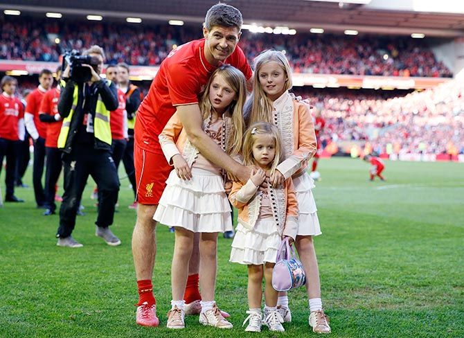 Steven Gerrard poses on the pitch with his family