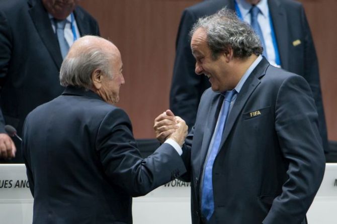 FIFA President Joseph S. Blatter (L) shakes hands with UEFA president Michel Platini
