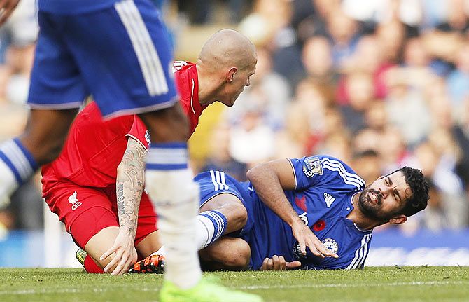  Chelsea's Diego Costa clashes with Liverpool's Martin Skrtel during their EPL match on Saturday