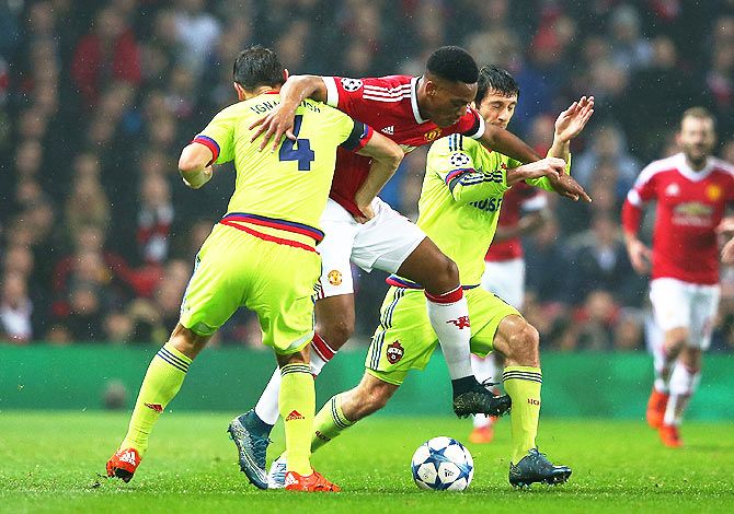 Manchester United's Anthony Martial battles for the ball with CSKA Moscow's Sergey Ignashevich (4) and Alan Dzagoev