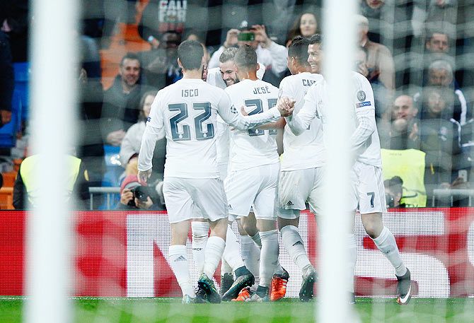 Real Madrid's Nacho Fernandez celebrates with teammates on scoreing their first goal against Paris Saint-Germain during the UEFA Champions League Group A match at Estadio Santiago Bernabeu in Madrid on Tuesday