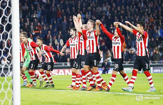 PSV Eindhoven's players celebrate after defeating Wolfsburg in their Champions League group B match in Eindhoven, Netherlands on Tuesday
