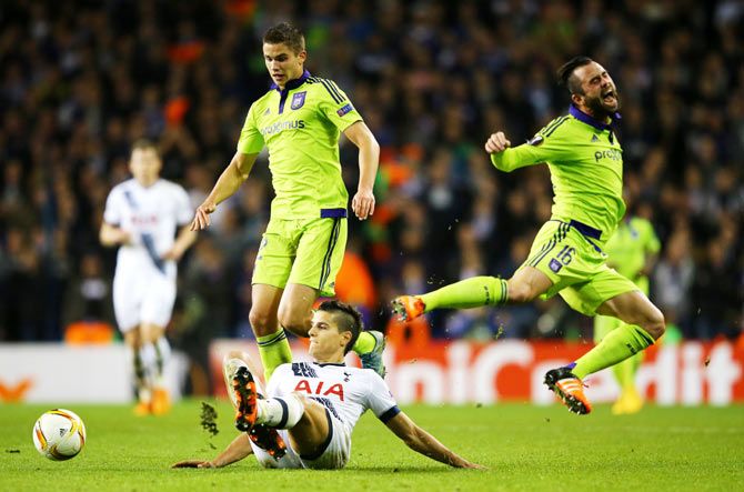 Anderlecht's Steven Defour is tackled by Tottenham Hotspur's Erik Lamela during their Group J match in London
