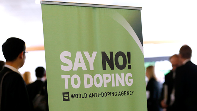 Participants talk before the start of the World Anti-Doping Agency (WADA) Symposium for Anti-Doping Organizations in Lausanne.