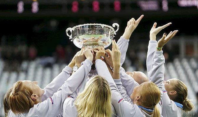Czech Republic's team celebrates with the trophy after winning their final match of the Fed Cup tennis tournament against Russia in Prague, Czech Republic on Sunday