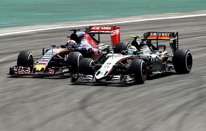 Max Verstappen of The Netherlands and Scuderia Toro Rosso (left) goes neck-to-neck against Sergio Perez of Mexico and Force India