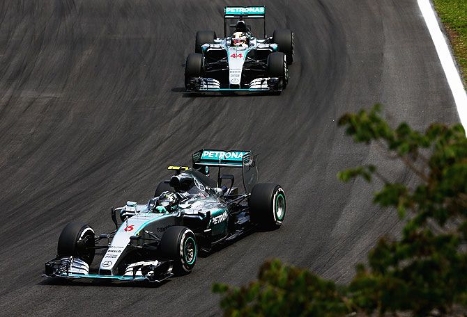 Germany and Mercedes GP's Nico Rosberg drives ahead of teammate Lewis Hamilton