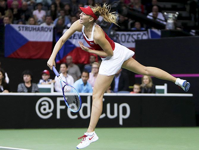 Russia's Maria Sharapova serves to Czech Republic's Petra Kvitova