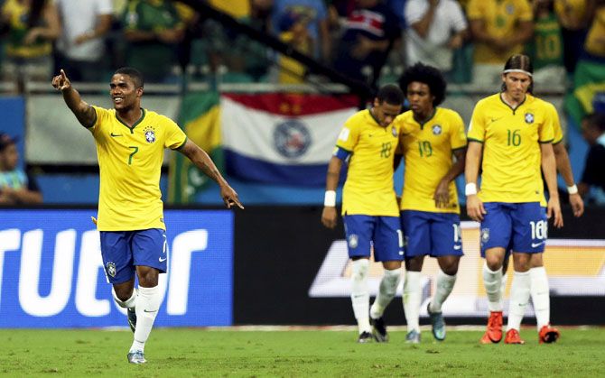 Brazil's Douglas Costa (left) celebrates a goal against Peru during their 2018 World Cup qualifying match in Salvador on Tuesday
