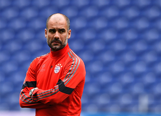 Head coach Pep Guardiola looks on during a FC Bayern Munich training session 