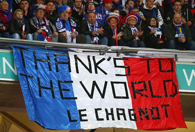 French supporters hold a banner to appreciate the support following the terror attack in Paris