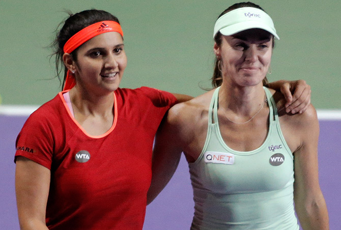 Switzerland's Martina Hingis and India's Sania Mirza celebrate winning the doubles final  