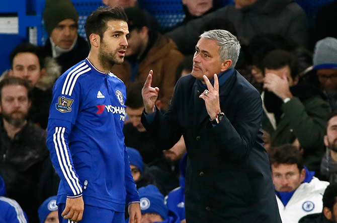 Chelsea's Cesc Fabregas talks to manager Jose Mourinho 