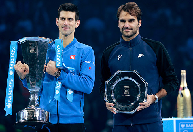 Serbia's Novak Djokovic and Switzerland's Roger Federer pose with their trophies after their match 