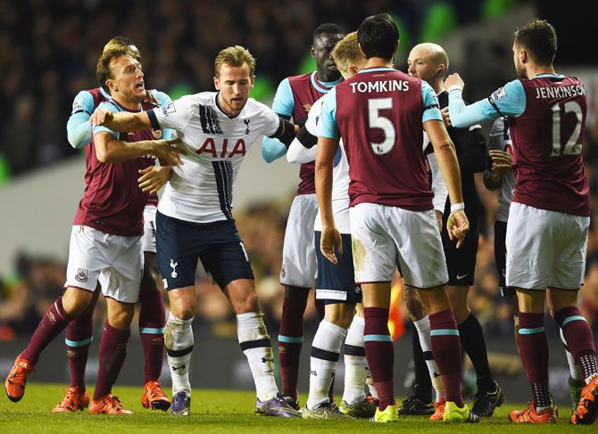 West Ham United's Mark Noble is held back by Tottenham Hotspur's Harry Kane as the players get into a tussle