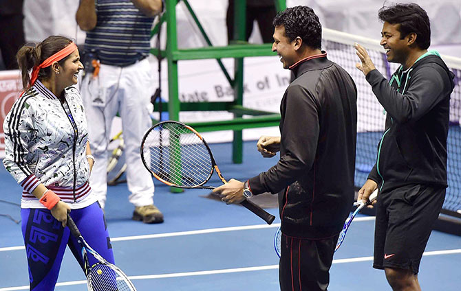 Leander Paes,Mahesh Bhupati and Sania Mirza share a light moments during an exhibition match at Netaji Indoor Stadium in Kolkata  