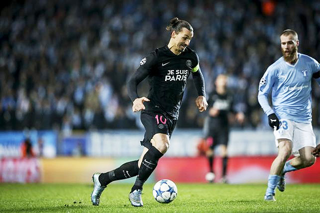 Paris SG's Swedish striker Zlatan Ibrahimovic (left) dribbles the ball past Malmo's Norwegian player Jo Inge Berget during their Champions League Group A match at Malmo New Stadium in Malmo, Sweden on Wednesday