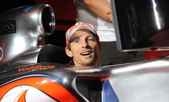 Jenson Button of Great Britain and McLaren takes part in a rain soaked Drivers Parad