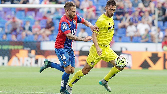 Levante's Roger challenges a Villareal player as they vie for possession