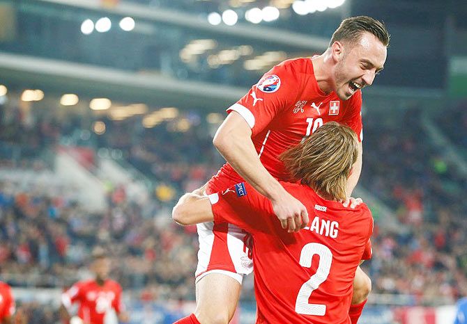 Switzerland's Michael Lang (right) celebrates his goal with teammate Josip Drmic during their Euro 2016 Group E qualifying match against San Marino's in St. Gallen, Switzerland on Friday