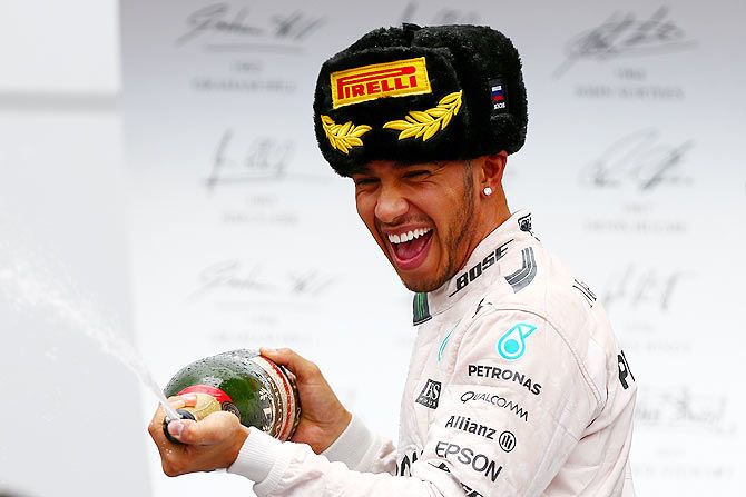 Mercedes GP's British driver Lewis Hamilton celebrates on the podium after winning the Russian Formula One Grand Prix at Sochi Autodrom in Sochi on Sunday