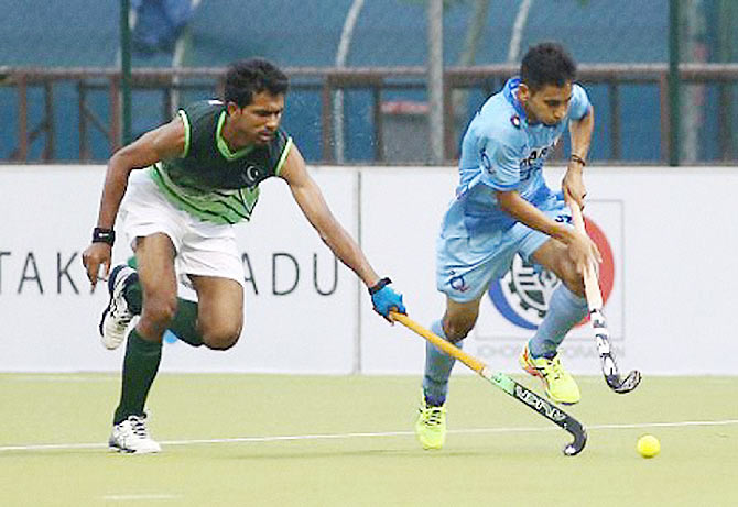 A player from India's Junior team and his Pakistani counterpart in action during the 5th Sultan of Johor Cup match in Johar Bahru, Malaysia, on Sunday