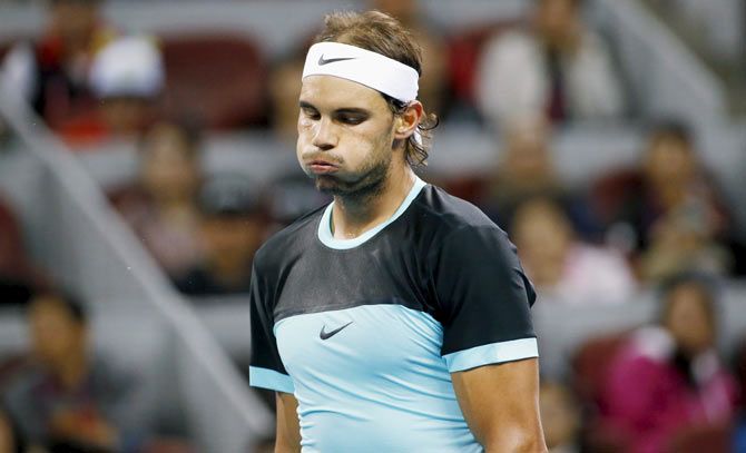 Rafael Nadal reacts after losing a point to Novak Djokovic