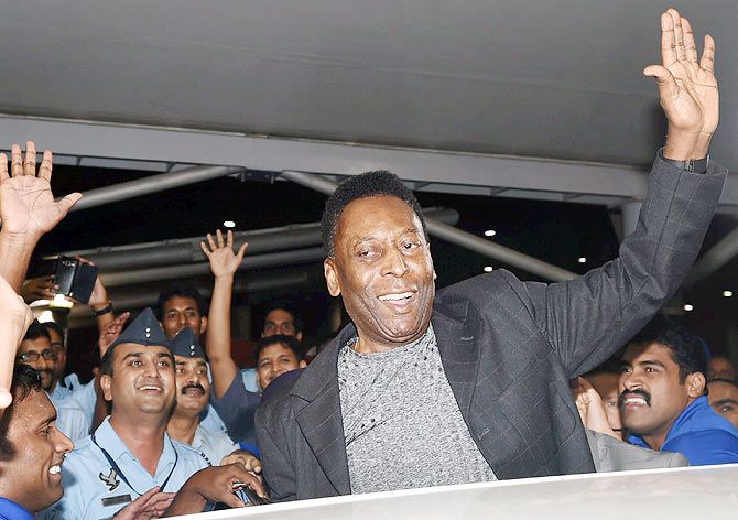 Brazilian soccer Legend Pele waves to his fans upon arrival at New Delhi's airport on Wednesday