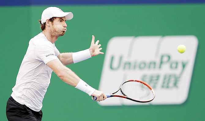 Great Britain's Andy Murray returns a shot against United States' John Isner during their third round match