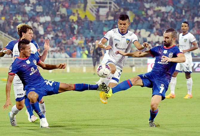Mumbai City FC (Blue) and Chennaiyin FC players in action 
