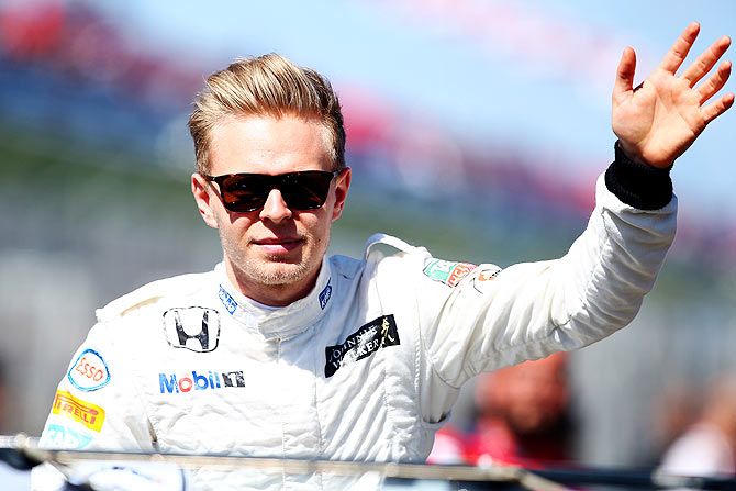 Kevin Magnussen of Denmark and McLaren Honda waves to the fans 