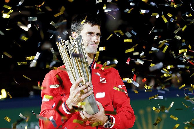 Serbia's Novak Djokovic poses with the winner's trophy after defeating France's Jo-Wilfried Tsonga in the Shanghai Masters final at the Qi Zhong Tennis Center at Qi Zhong Tennis Centre in Shanghai, on Sunday