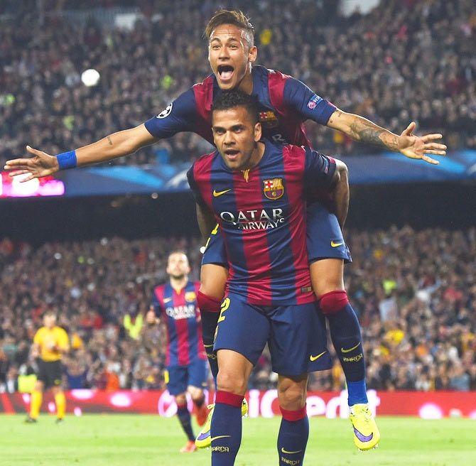 Barcelona's Neymar celebrates with teammate Daniel Alves (front) after scoring at Camp Nou