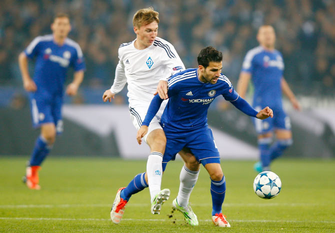 Chelsea's Cesc Fabregas is challenged by an FC Dynamo Kyiv player during the UEFA Champions League Group G match at the Olympic Stadium in Kiev on Tuesday