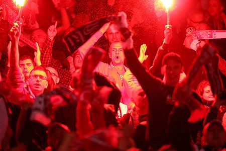 Polish fans set off flares after Poland scores a late equaliser during the UEFA EURO 2016 qualifier between Scotland and Poland at Hampden Park in Glasgow on October 8