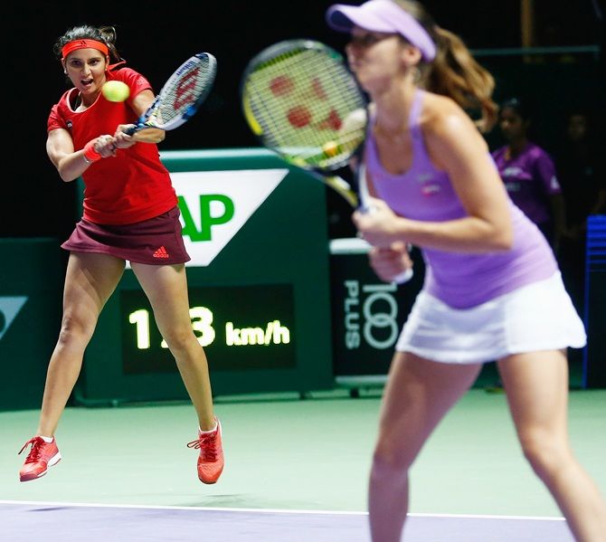  India's Sania Mirza and Switzerland's Martina Hingis in action against Raquel Kops-Jones and Abigail Spears of the USA during the WTA Finals at Singapore Sports Hub