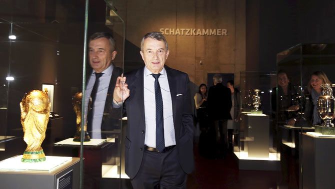 Wolfgang Niersbach, president of the German Football Association (DFB), stands next to the trophy of the Brazil 2014 World Cup in the treasure room during the opening of the new German soccer museum in Dortmund