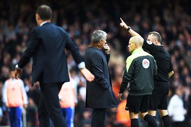 Chelsea manager Jose Mourinho looks on as Referee Jonathan Moss sends him to the stands along with goalkeeping coach Christophe Lollichon and assistant first team coach Silvino Louro