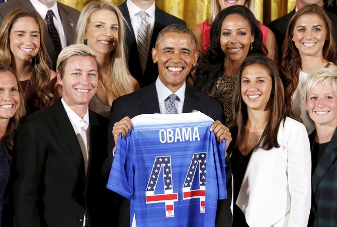 US President Barack Obama holds a jersey given to him during an event honoring the United States women's soccer team