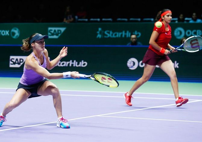 Switzerland's Martina Hingis, left, and India's Sania Mirza in action