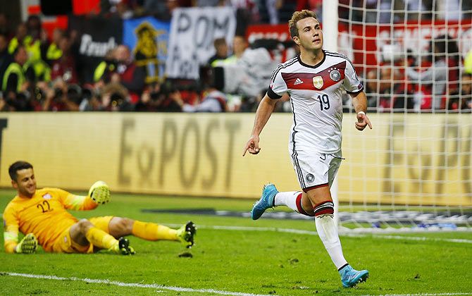 Germany's Mario Goetze (right) celebrates after he scoring against Poland during their Euro 2016 qualifiiers in Frankfurt on Friday