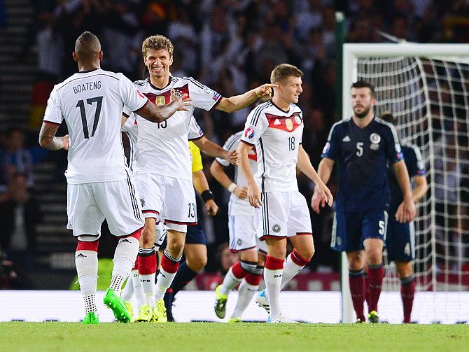 Thomas Mueller celebrates with his teammates scoring during the EURO 2016 Qualifier between Scotland and Germany at Hamden Park in Glasgow on Monday