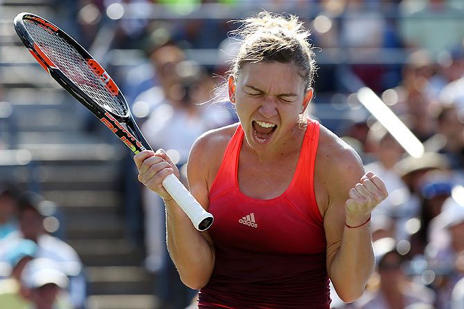 Romania'S Simona Halep celebrates after defeating Germany'S Sabine Lisicki during their fourth round match of the US Open on Monday
