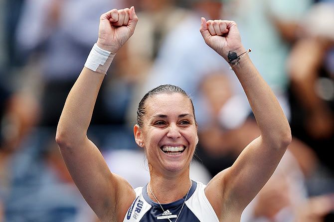 Italy's Flavia Pennetta celebrates after defeating Romania's Simona Halep in their women's singles semi-finals on Friday