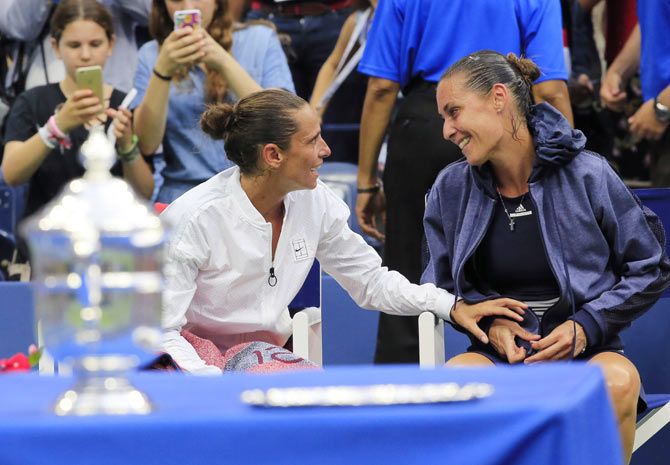 Runner-up Roberta Vinci (left) talks with compatriot and tournament winner Flavia Pennetta following their women's singles final on Saturday