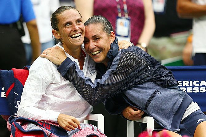 Flavia Pennetta (right) shares a light moment with compatriot Roberta Vinci after winning the US Open women's singles title