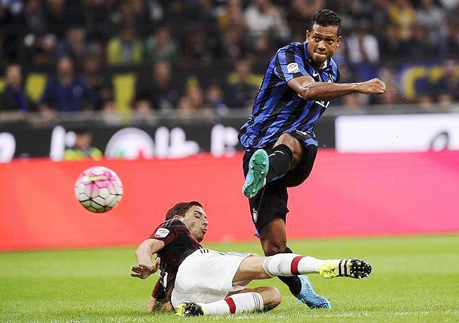 Inter Milan's Fredy Guarin (right) shoots to score during the Italian Serie A match against Inter Milan at the San Siro stadium in Milan, on Sunday